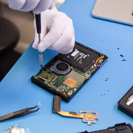 Engineer repairing a Nintendo Switch console