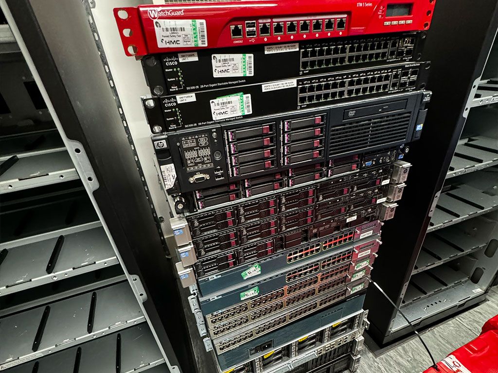 Server rack with Cisco switches and an HP server awaiting decommissioning